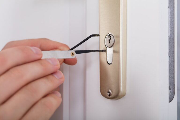 Locksmith opening a door lock with a pick and tension tool